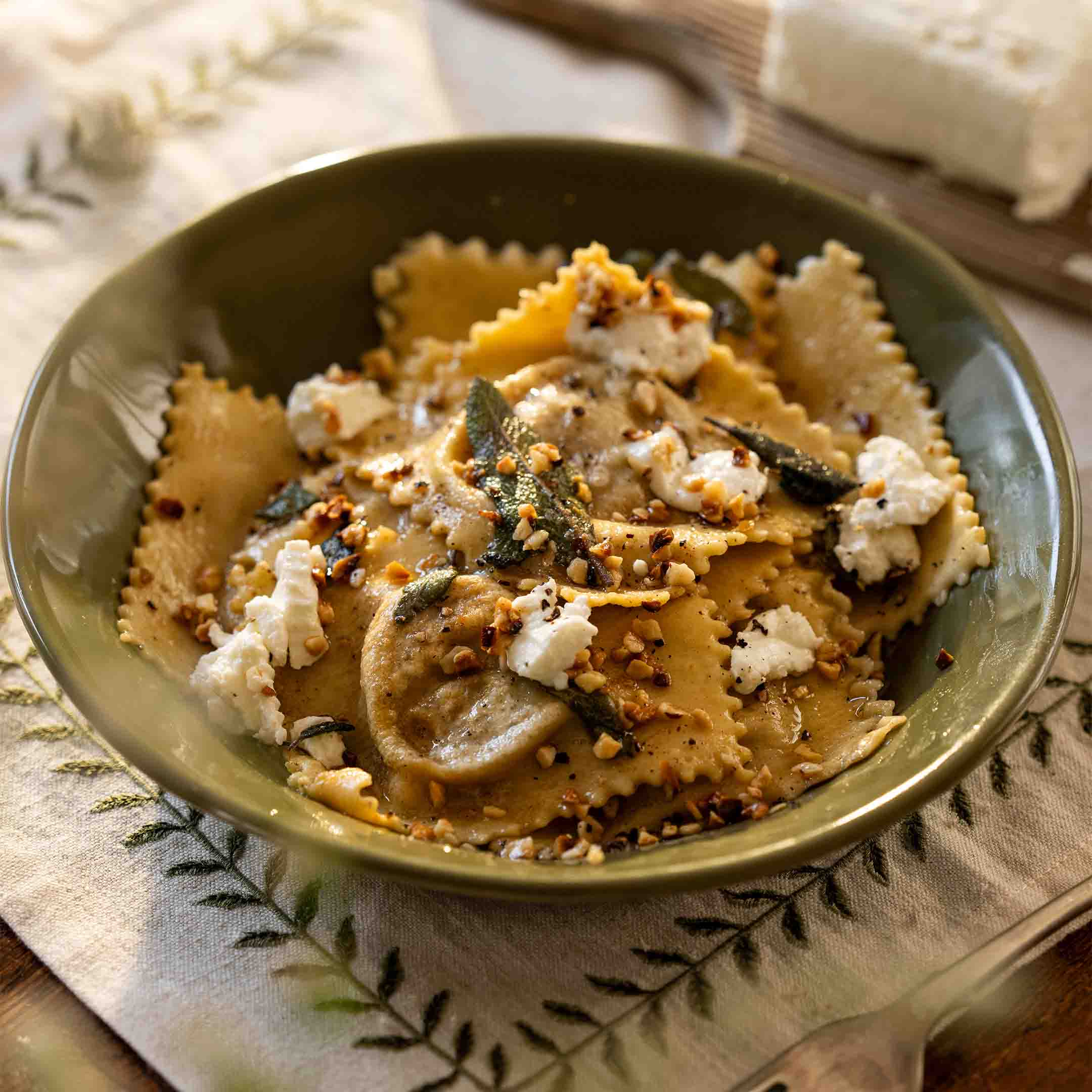 Ravioli with squash and sage, hazelnuts and goats cheese